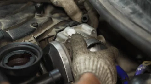 Mechanic installing air intake hose onto car throttle body assembly. Stock Footage 341486806