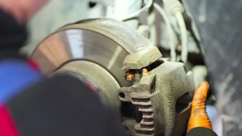 Mechanic Installing Brake Caliper on Disc Close Up Stock Footage 331704167