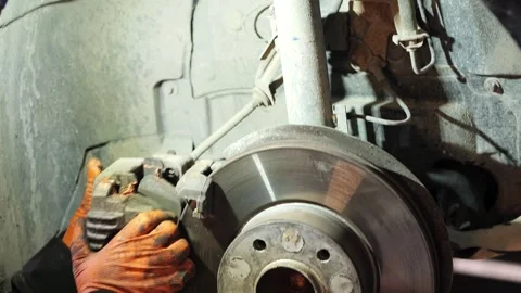 Mechanic Installing Brake Caliper on Disc Close Up 2026 Video stock 331704173