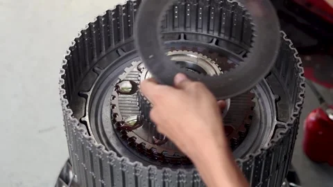 Mechanic installing clutch plate into automatic transmission drum. Stock Footage 344026077