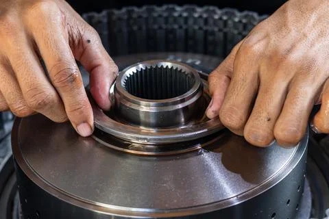 Mechanic Installing Ring on Automatic Transmission Clutch Assembly. Stock Photos