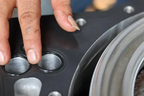 Mechanic installing rubber o-ring seal on metal component. Stock Photos