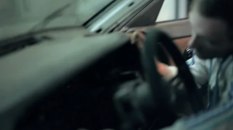 Mechanic installs in car dashboard Stock Footage