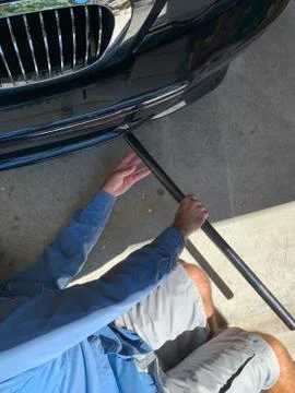 Mechanic Jacking Up Vehicle Stock Photos