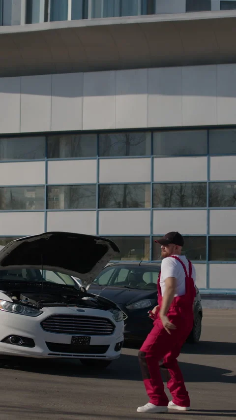 Mechanic joy dances reflecting sense success from completing done repair job Stock Footage 273767367