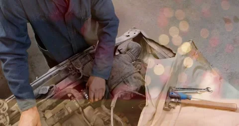 Mechanic leaning over car engine in workshop, showing animated data bars, Stock Footage 330479299