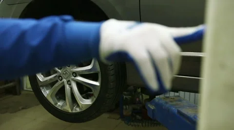 Mechanic lifts the machine holding the button lift Stock-Footage 62480651