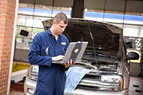 Mechanic: looking at engine test results Stock Photos