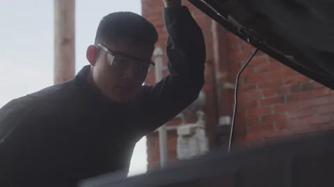 Mechanic Looking for the Engine's Problem Stock Footage 208779609