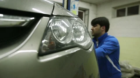 Mechanic lowers the machine holding the button lift Stock Footage 62481532