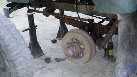 Mechanic man changing a wheel on an old car Stock-Footage 137125572