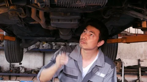 Mechanic man checklist about car problem at garage. Stock Footage 99472073