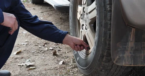 Mechanic man hands checking car tires outdoor on site service auto garage for au Vídeo Stock 232286029