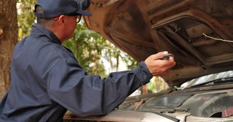 Mechanic man hands checking car tires outdoor on site service auto garage for au Stock Footage 232293555
