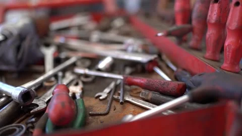 Mechanic man in industry taking pliers from tool bench Stock Footage 180887463