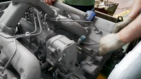 Mechanic manufacturing engine or motor for tractor or truck on manufacturing Stock Footage 146433381