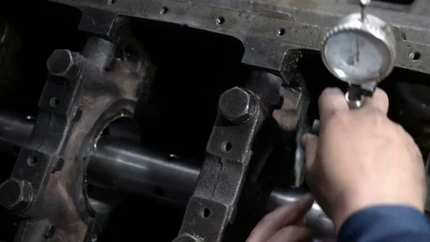 Mechanic measures the inner surface of the engine block with a micrometer Stock Footage 75313204