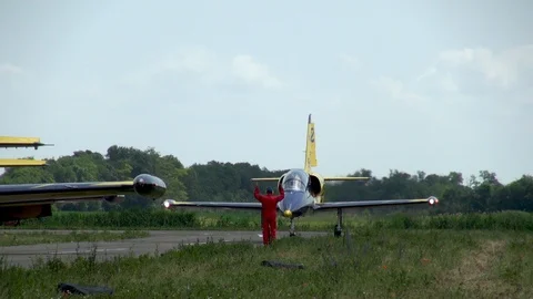 Mechanic meets L-39 plane from aerobatic team of Baltic bees after flight. Stock Footage 121446730