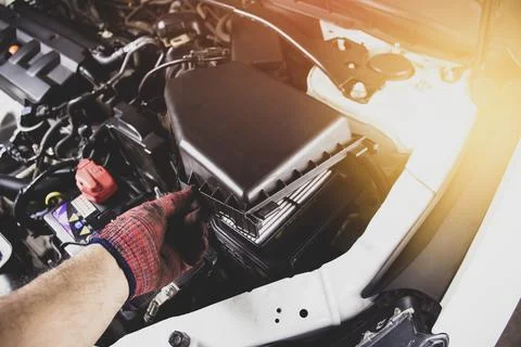 The mechanic is opening the engine air filter Stock Photos