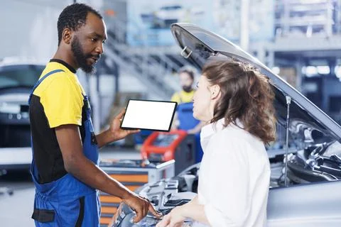 Mechanic orders engine on mockup tablet Stock Photos