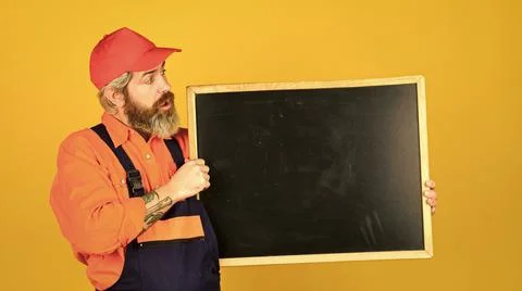 Mechanic perform technical work. Man worker hold chalkboard copy space Stock Photos