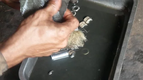 A mechanic performs repairs, maintenance and cleaning on a motorbike CVT Stock Footage 312517573