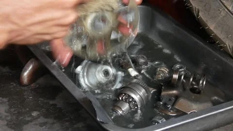 A mechanic performs repairs, maintenance and cleaning on a motorbike CVT Stock Footage 312517634