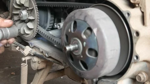 A mechanic performs repairs, maintenance and cleaning on a motorbike CVT Stock Footage 312517712