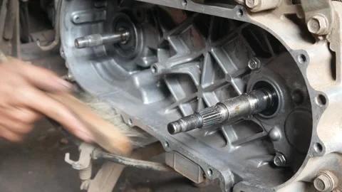 A mechanic performs repairs, maintenance and cleaning on a motorbike CVT Stock Footage 312517746