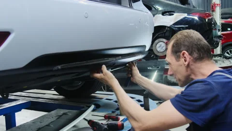 Mechanic performs task to repair body of automobile rear Video stock 317633544