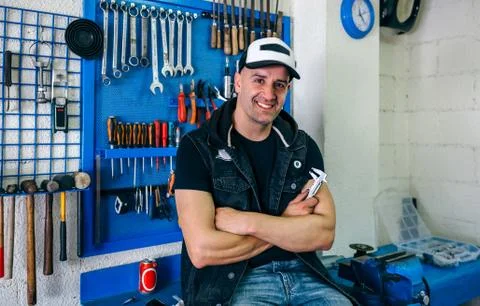 Mechanic posing with a motorcycle Stock Photos