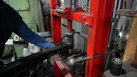 Mechanic pressing new silent blocks into the rear suspension 動画素材 297687210