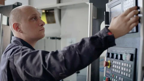 Mechanic programming CNC machine on industrial plant, modern equipment. Stock Footage 94998140