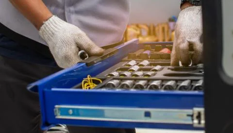 Mechanic pulls the blue tool tray to fix the car. Stock Photos