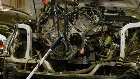 A mechanic pushes a engine into an empty... | Stock Video | Pond5