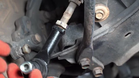 The mechanic is putting on the ball joint of the car.  Video stock 243732116
