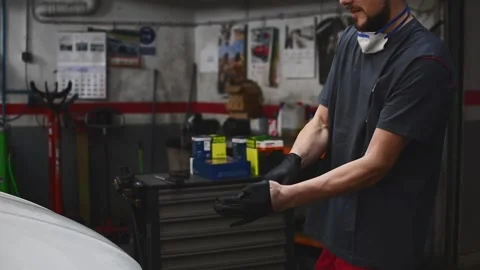 Mechanic putting on work gloves Stock Footage 132304045