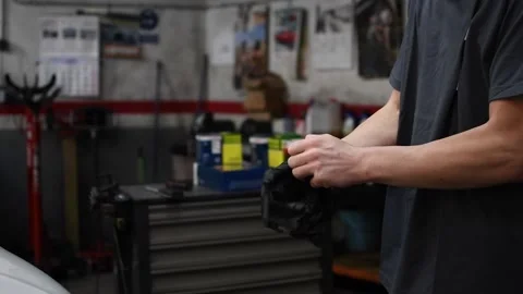Mechanic putting on work gloves Stock Footage 132304047
