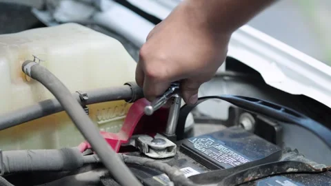Mechanic ratcheting a car battery Stock Footage 328580761