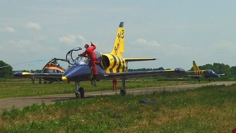 Mechanic in red overall sets stoppers inejection seat aircraft L-39. Video stock 106607601