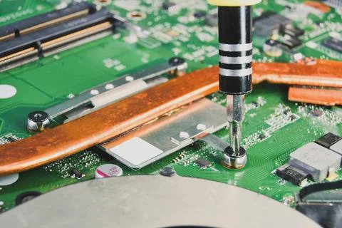Mechanic remove a bolt from the CPU heatsink cooler Stock Photos
