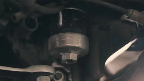 Mechanic remove screwdriver to drain the filter old oil engine on motorcycle Stock Footage 152967576