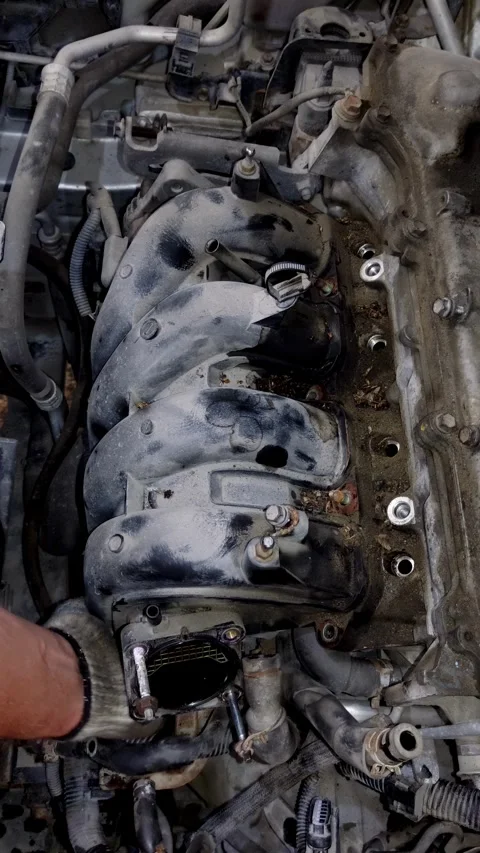 A mechanic removes a plastic intake manifold from car engine. Stock Footage 339492036