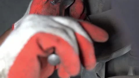 The mechanic is removing the ball joint nut. Video stock 244856826