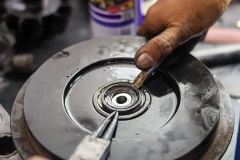 Mechanic Removing Circlip Retaining Ring from Turbocharger Backplate Seal U.. Stock Photos