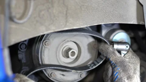 Mechanic Removing Engine Belt Using Wrench and Glove Stock Footage 346119112