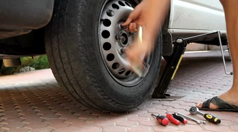 Mechanic removing lug nuts.  shot motorized slider. Stock Footage 8833342
