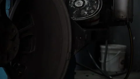 Mechanic removing old damaged and worn out of car tire tread by tire removal Stock Footage 147368827