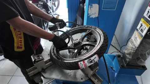 A mechanic is removing an outer tire using a machine Video stock 292817864