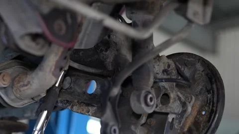 Mechanic Removing Rusty Brake Disc from Car Wheel Hub Stock Footage 345565315